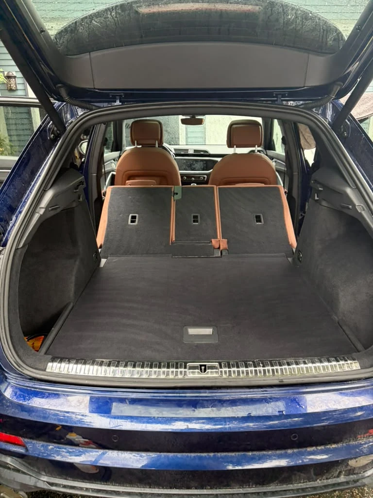 Blue Audi SUV cargo area cleaned with rear seats folded, Newton MA mobile detailing