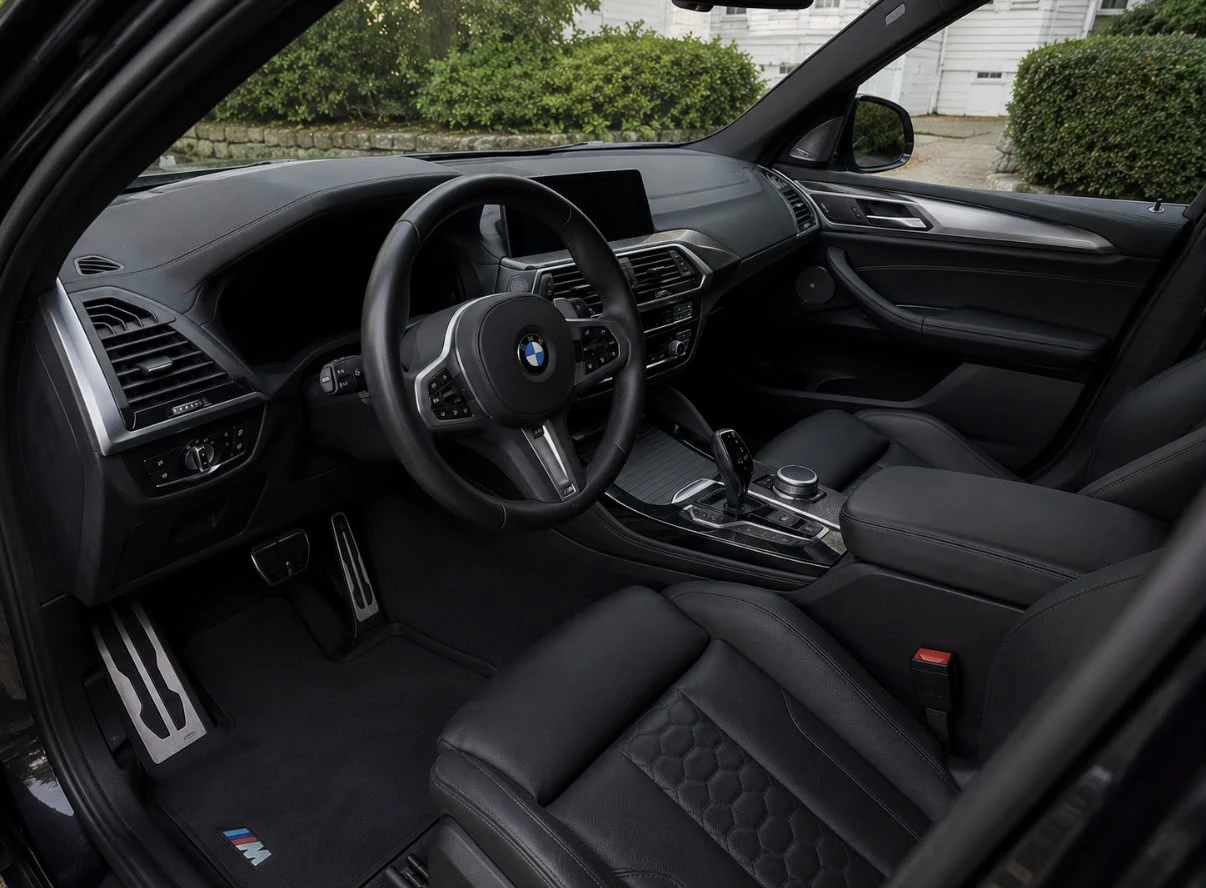 Detailed BMW X3 M black leather interior, steering wheel and dashboard, Newton MA