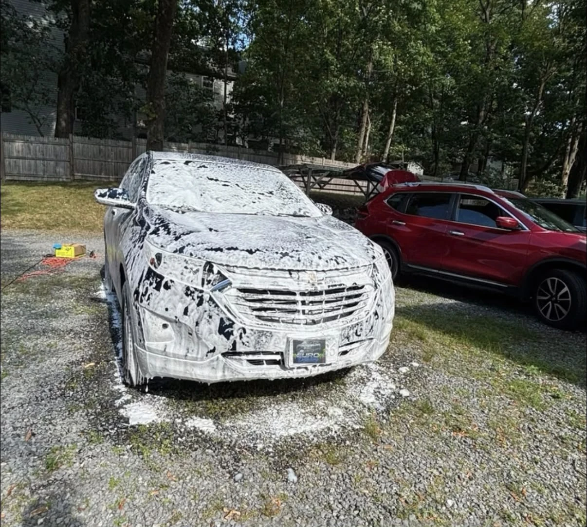 Chevrolet SUV covered in snow foam during a mobile hand wash in Newton, MA