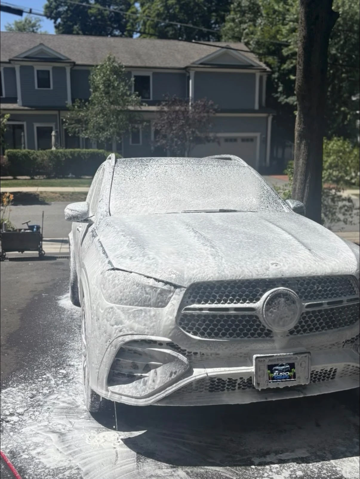 Mercedes-Benz GLE covered in snow foam during a wash in Newton, MA